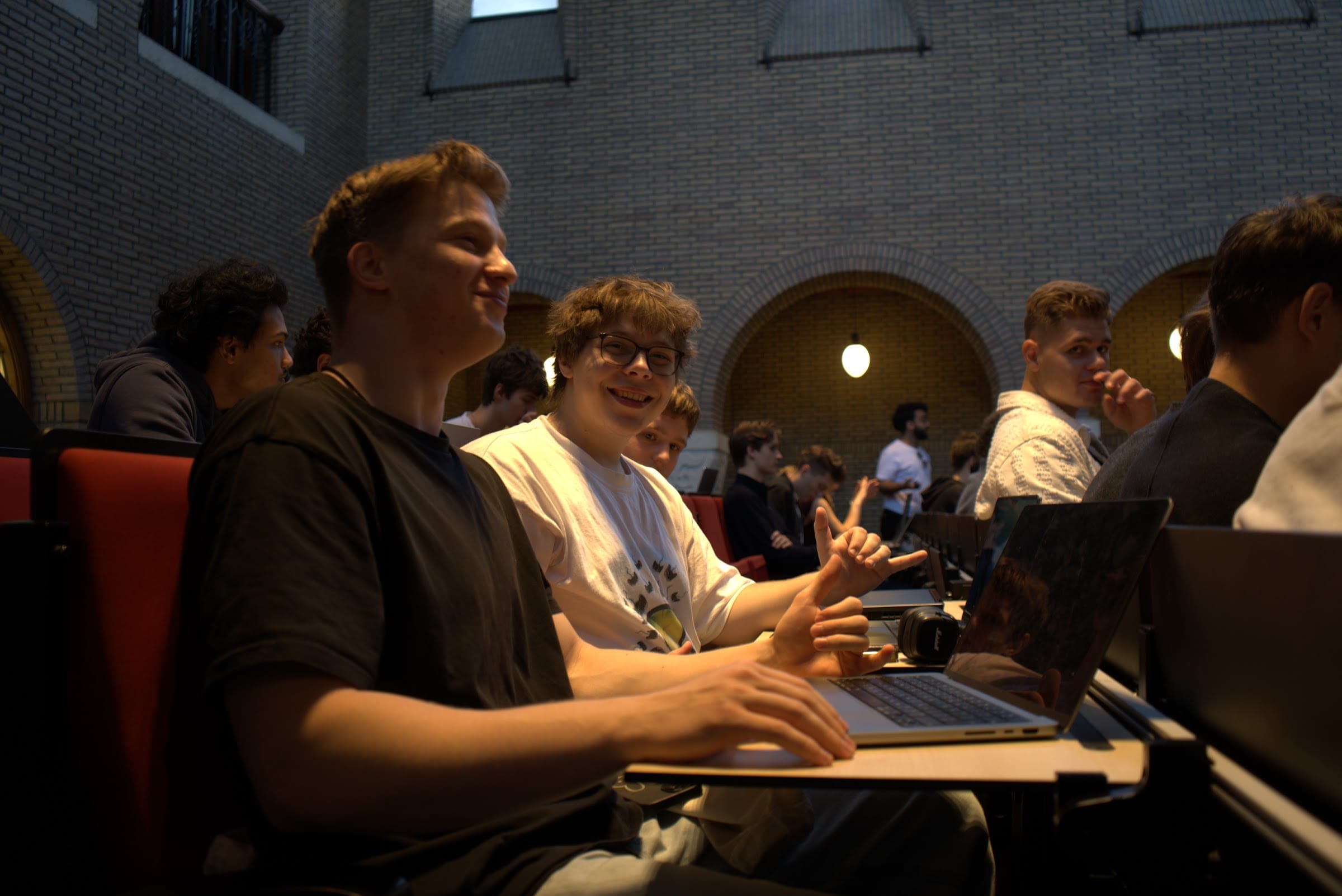 Two students at a laptop in the lecture hall during the hackathon